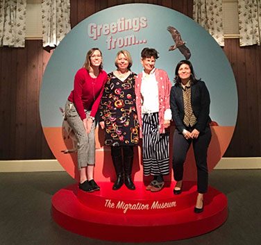 Four women in a snow globe photobooth.